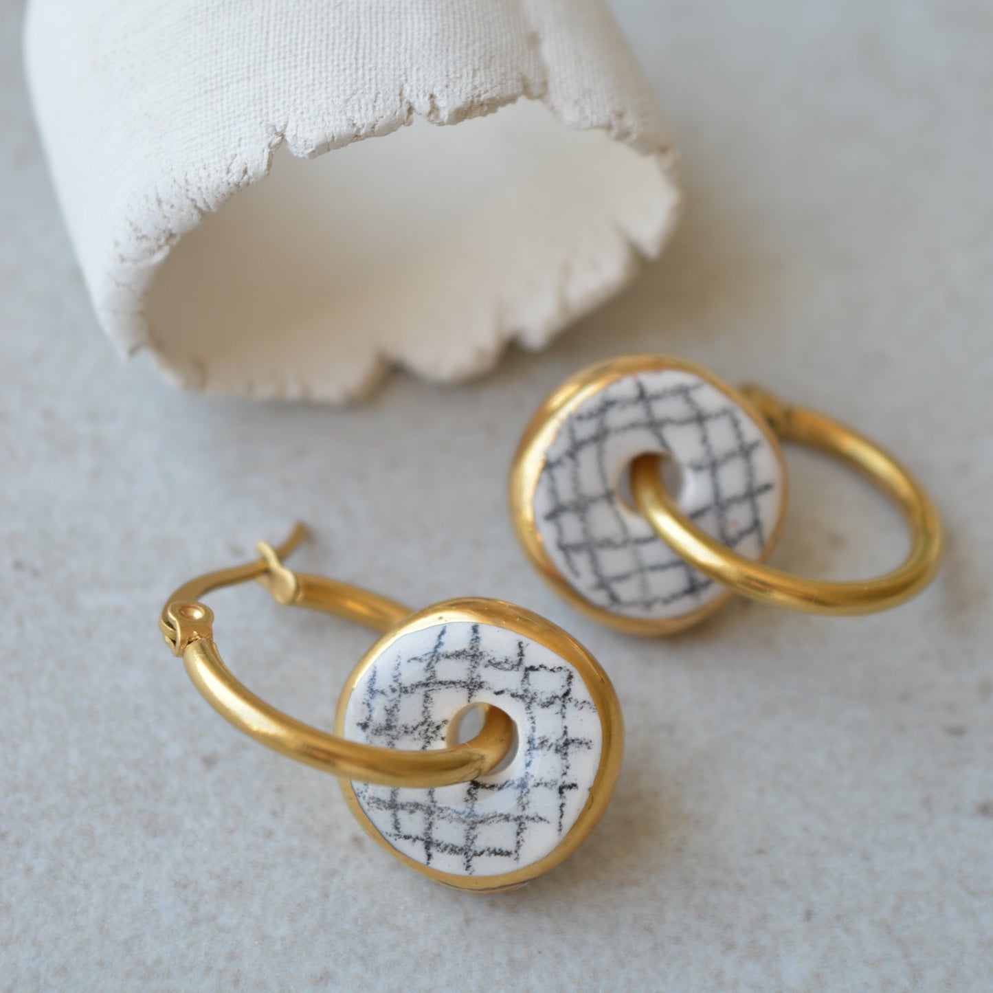 gold ceramic hoop earrings with geometric pattern