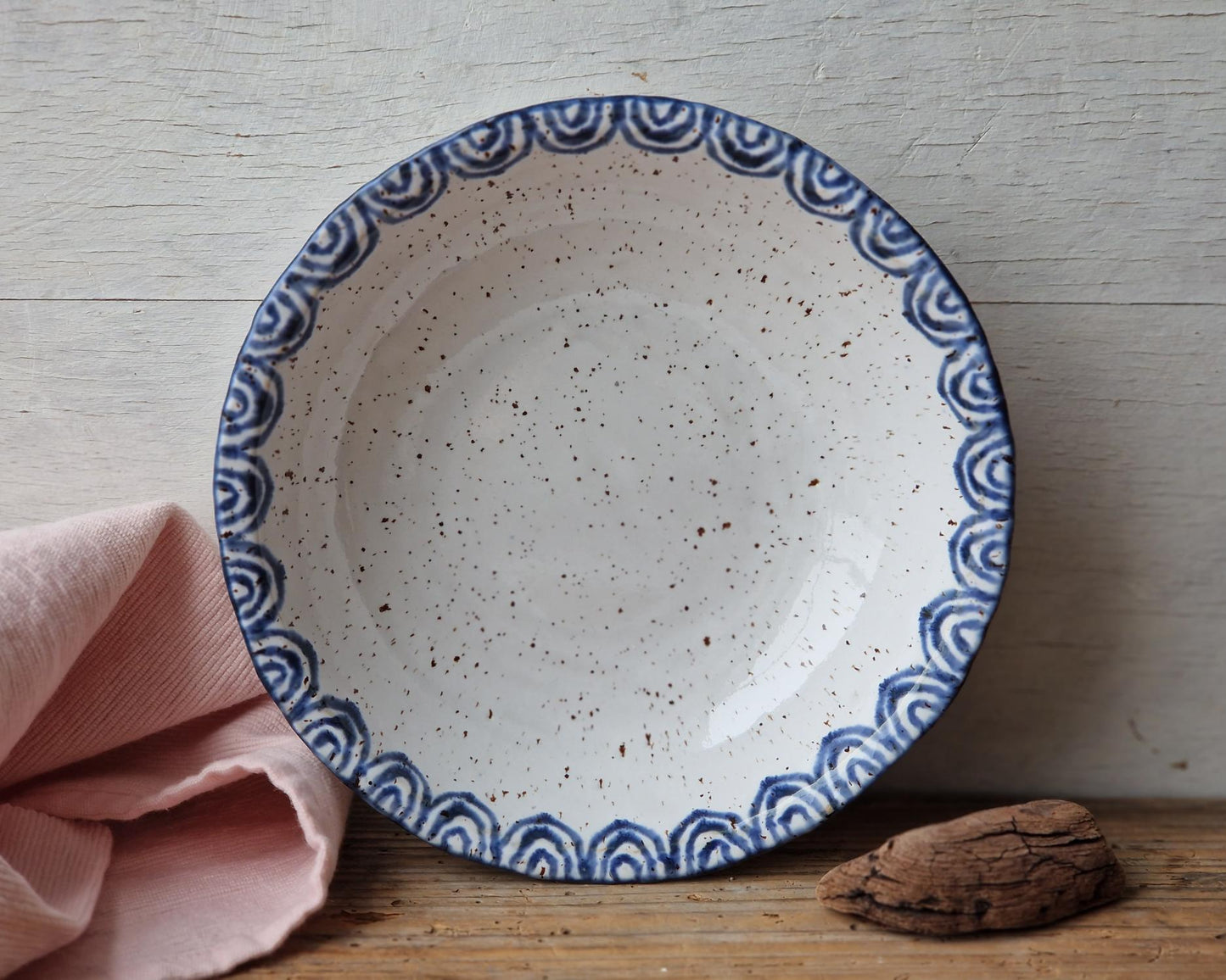 Handmade ceramic bowl with blue decorative rim