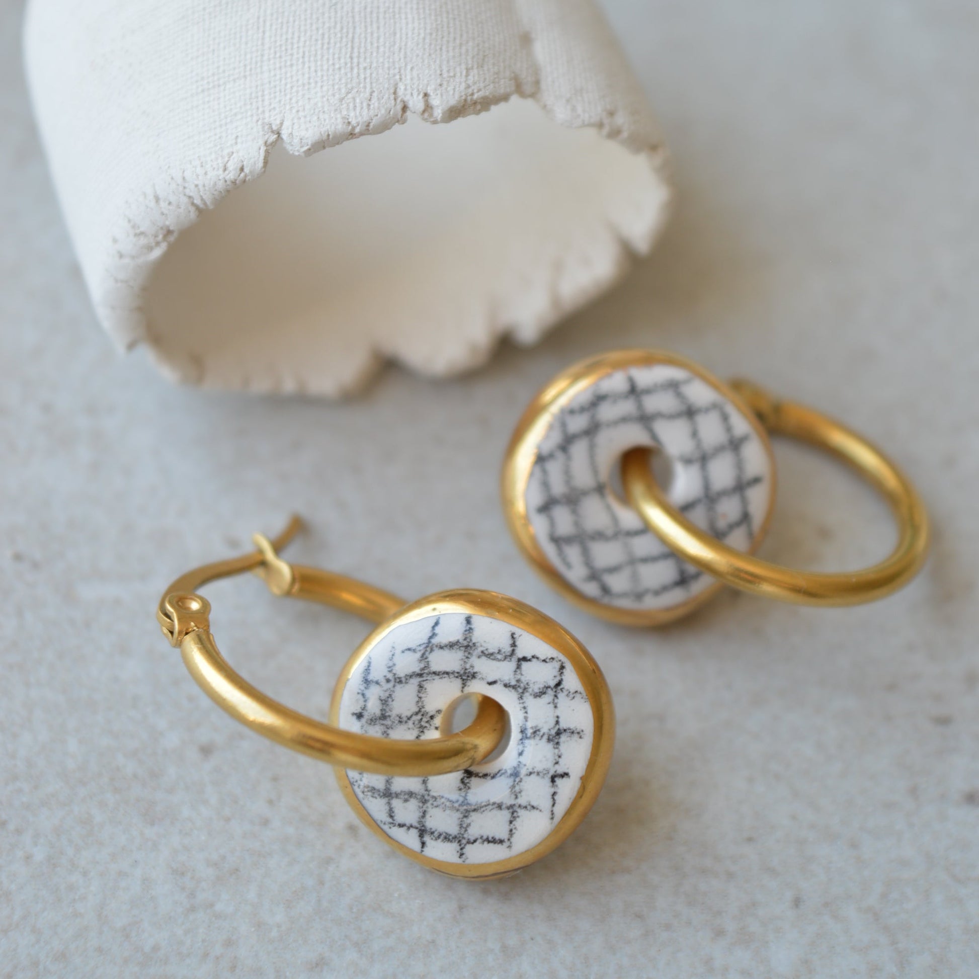 gold ceramic hoop earrings with geometric pattern